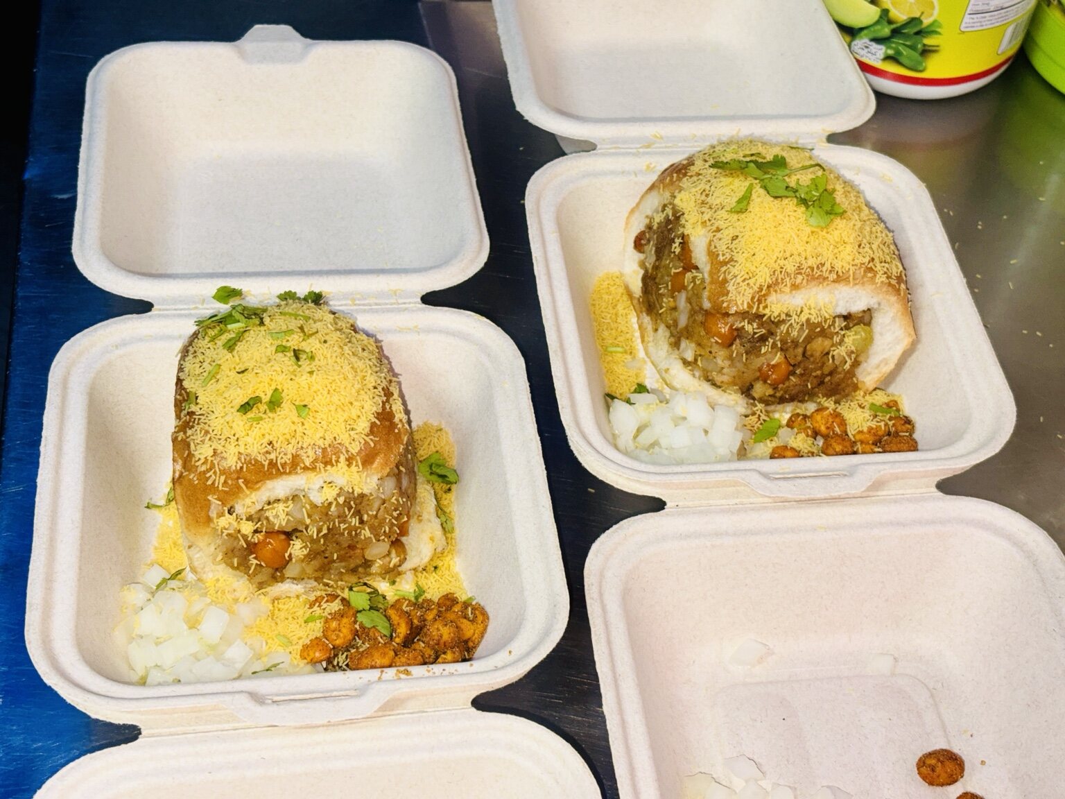 Multiple packaged Chaat on Wheels orders prepared for guests