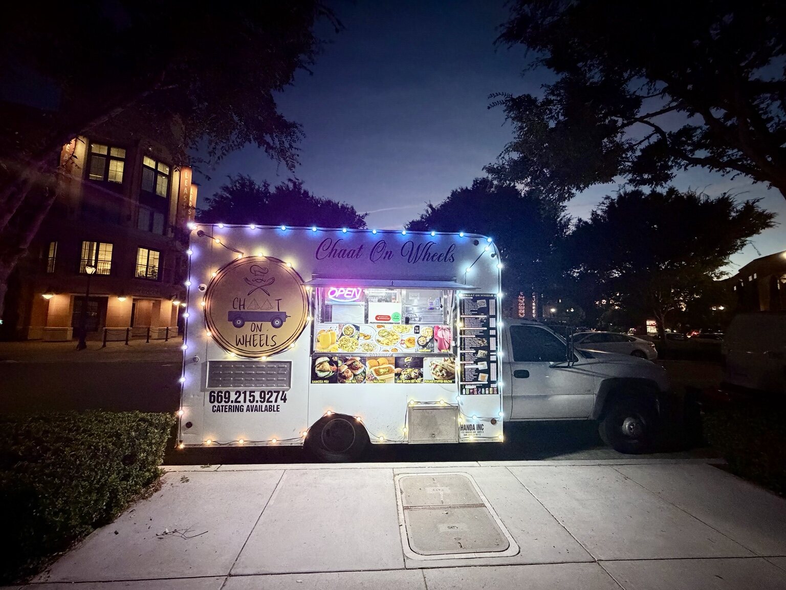 Chaat on Wheels food truck lit up for nighttime service