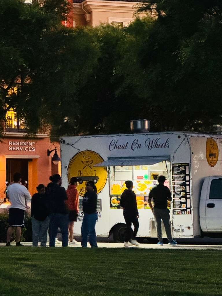 Guests ordering from the Chaat on Wheels food truck during evening service