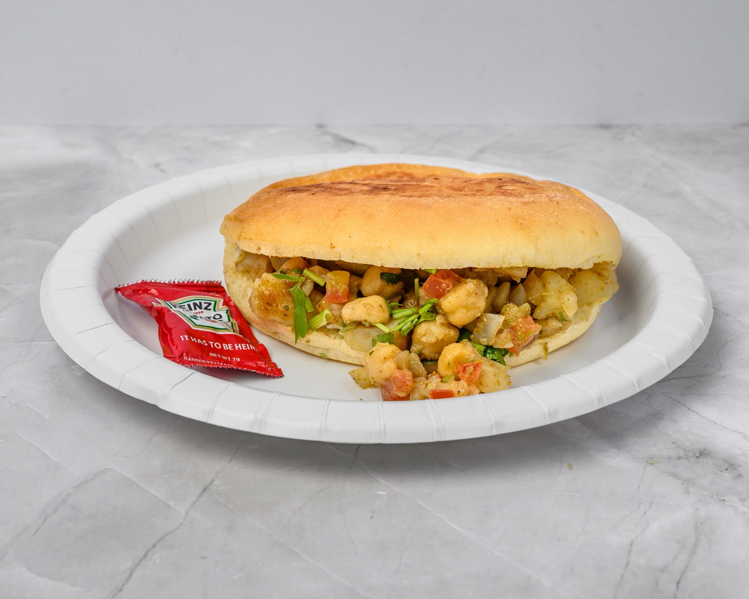 Vegetarian sandwich filled with spiced potatoes, chickpeas and fresh cilantro